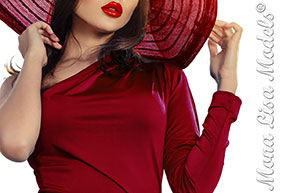 Model in red holding her hat